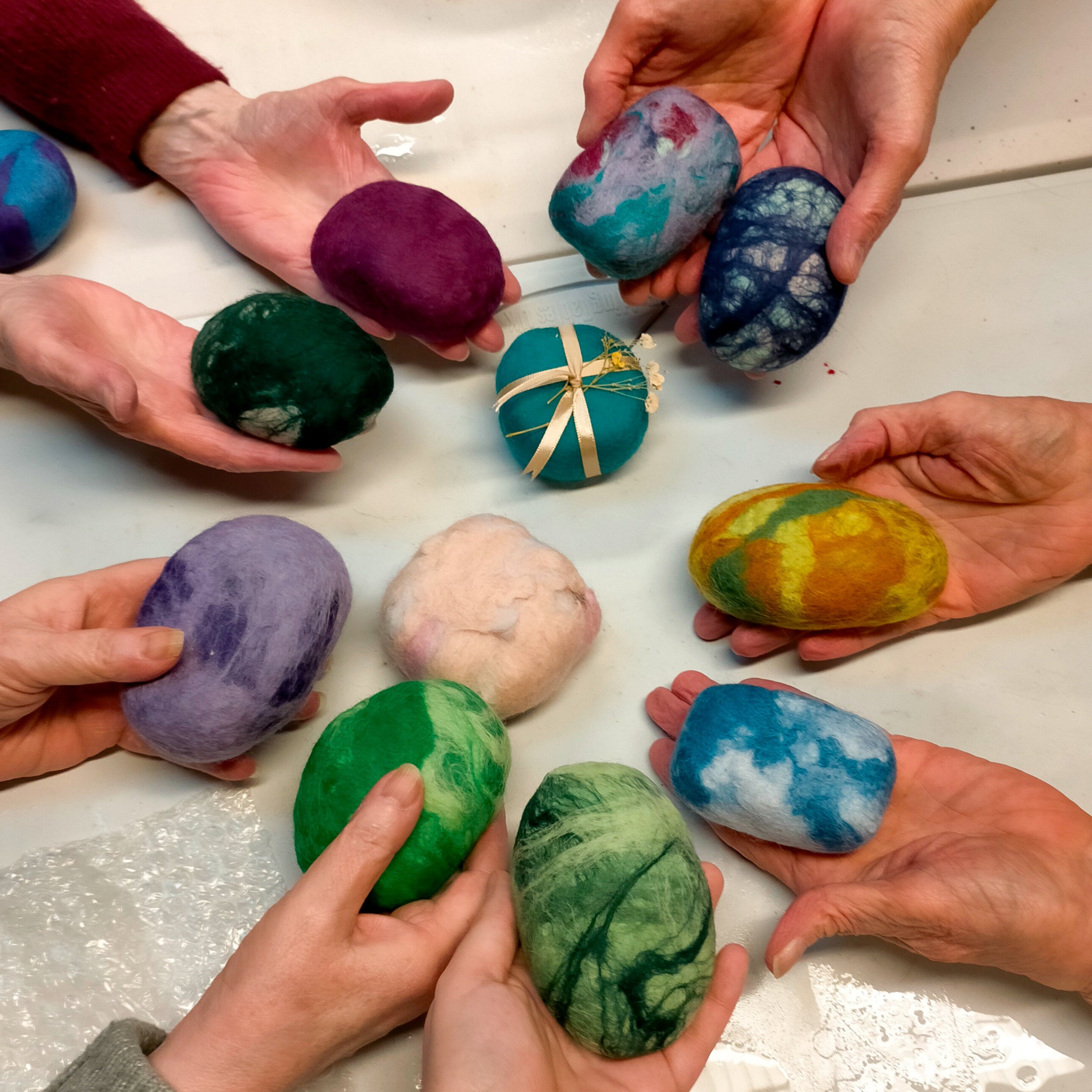 A collection of nine unique soaps made during our creating soap wet felting workshop.